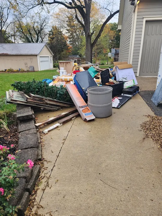 Dumpster being loaded with debris for 3 Yard Dumpster Rental in Farmers Loop